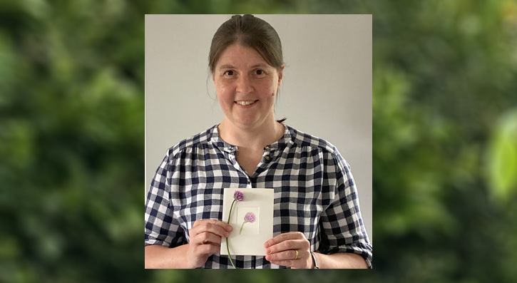 Part-time student Helen McAneney holding an example of her floral art 